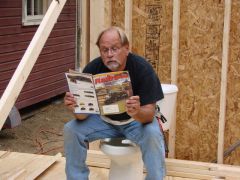 Dry run. LMRC member Terry Friar test drives the “reading throne”. At this stage of the game the projected costs of getting a water and sewer line from the street to the building were escalating from high to ludicrous to insane and there was concern that it might remain dry for the forseeable future.