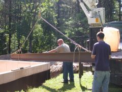 A steel beam, thick enough so that no intermediate supports are required, has been delivered and is being set.