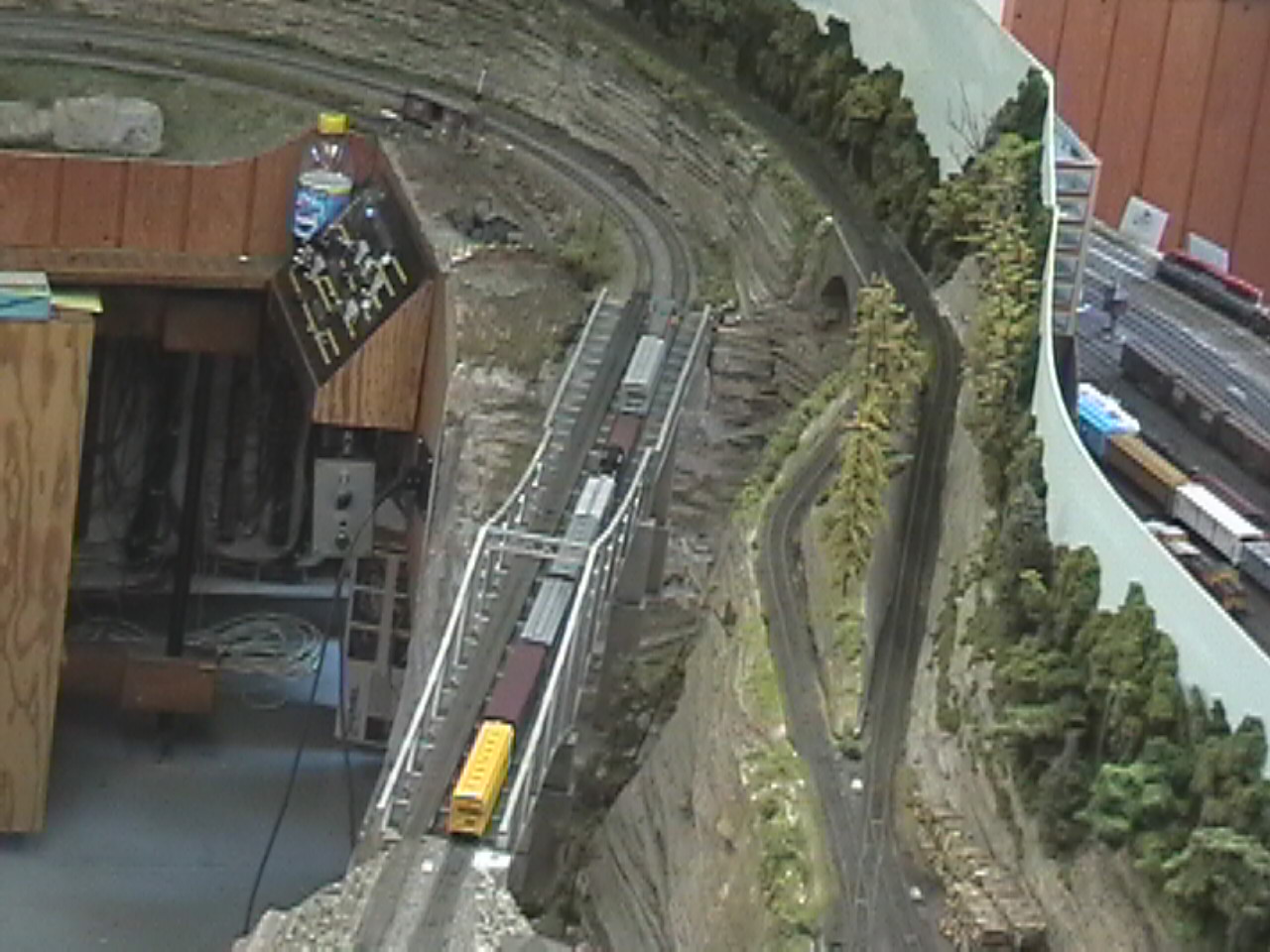 North east asile of the layout room showing the Lawarence Valley bridge (center) and branch line to Zekes (right).